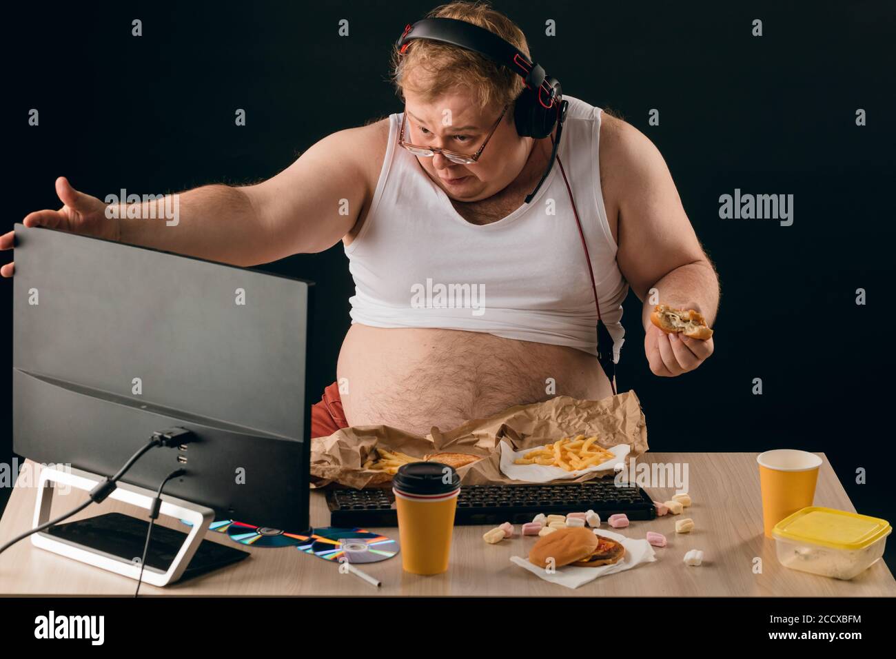 obese-man-talking-with-a-computer-close-up-portrait-isolated-black-backgroundlifestyle-concept...jpg