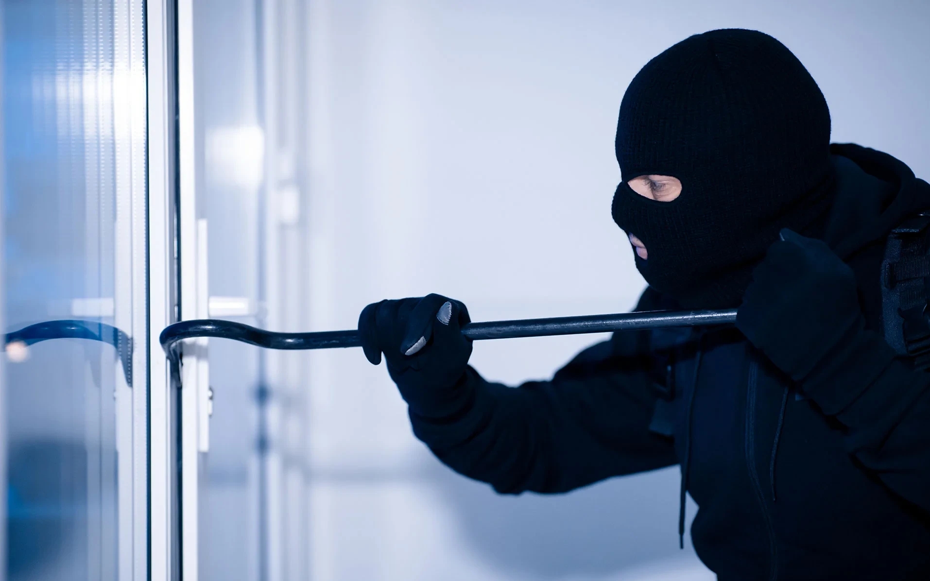 robber-in-black-balaclava-cracking-door-with-crow.jpg~2.jpg