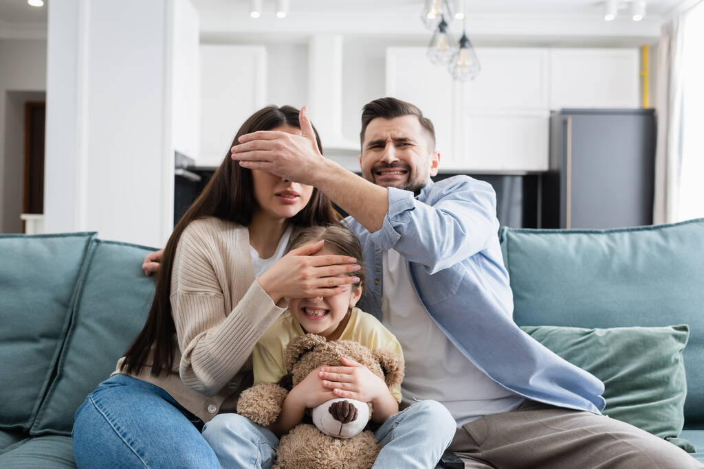 stock-photo-scared-family-covering-eyes-each-other-while-watching-horror-film.jpeg